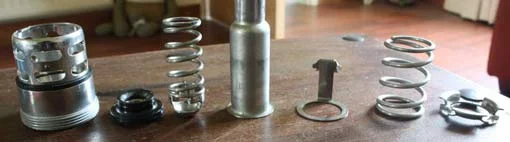 All the valve parts laid out on a table in the order they go back together